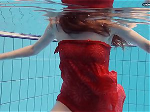 crimson clothed teen swimming with her eyes opened